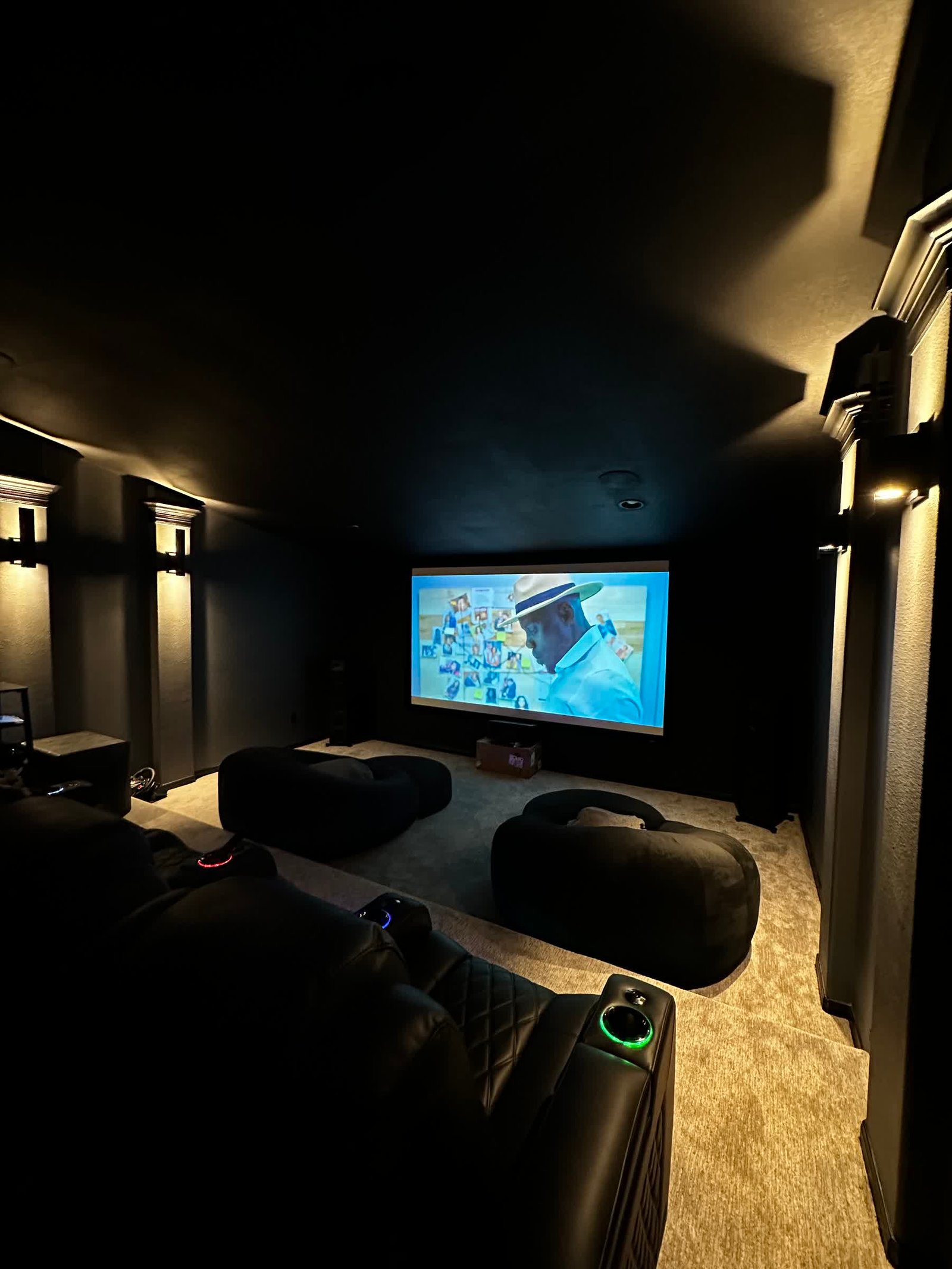 Custom cinematic theater with projection and recliner seating